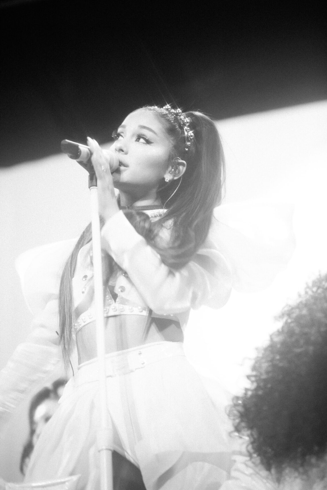 Ariana Grande signing during a performance