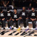 Members of the Los Angles Lakers kneeling during the national anthem in the NBA Bubble
